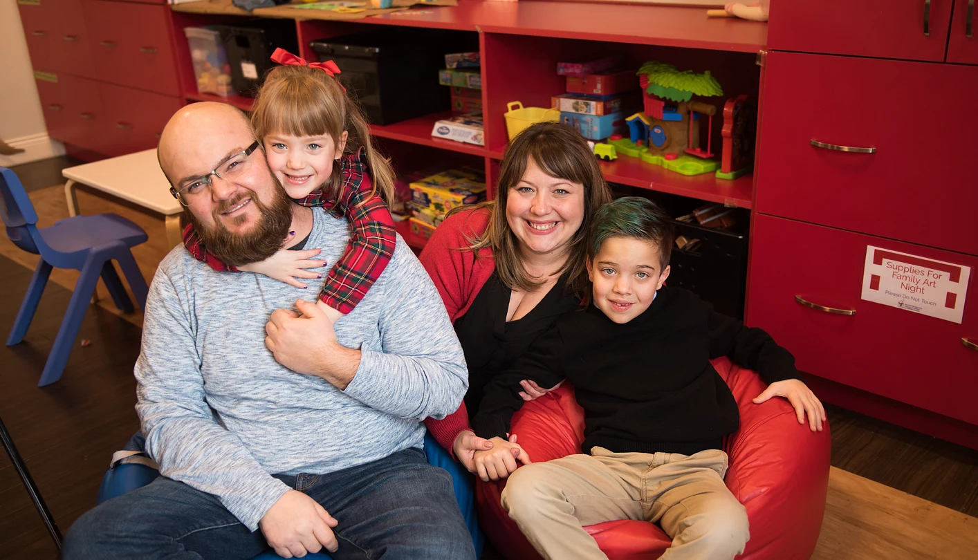 the vlad family sitting in a play room